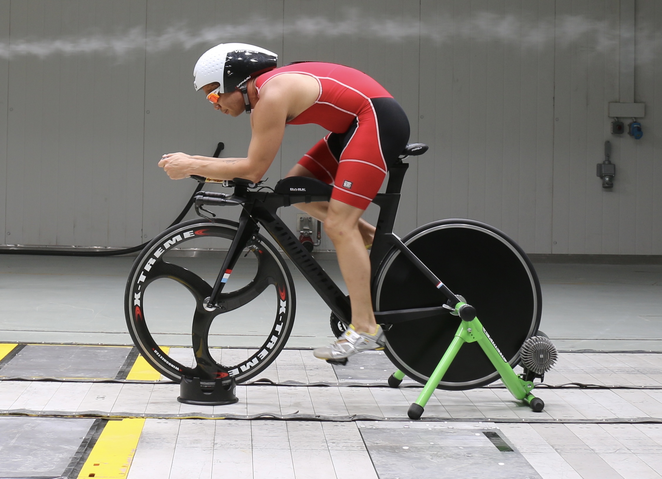 Cyclist on a bike in the climatic wind tunnel.