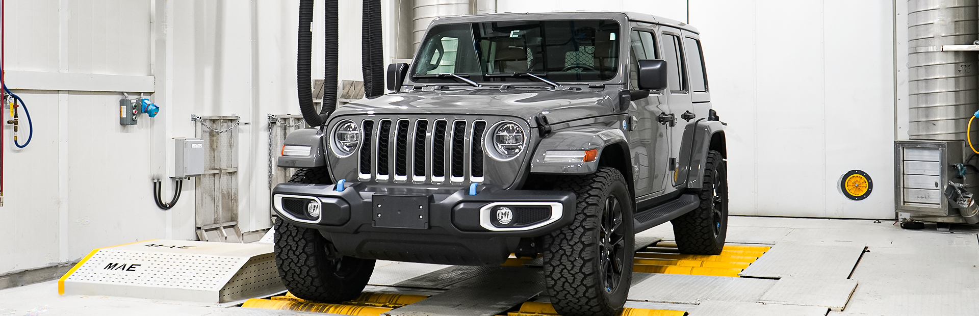 A gray Jeep Sahara is on the dyno under the solar array in the Large Climatic Chamber.