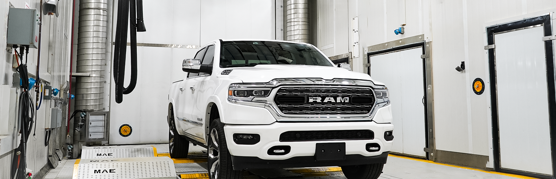 A white Dodge Ram is on the dyno in the Large Climatic Chamber.