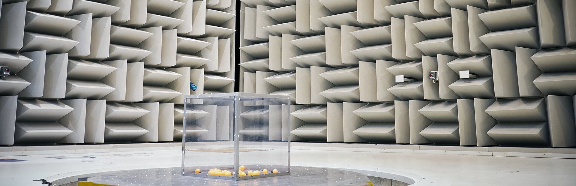 Orange ping pong balls are in a clear box on the MAST in the Hemi-Anechoic Chamber. 