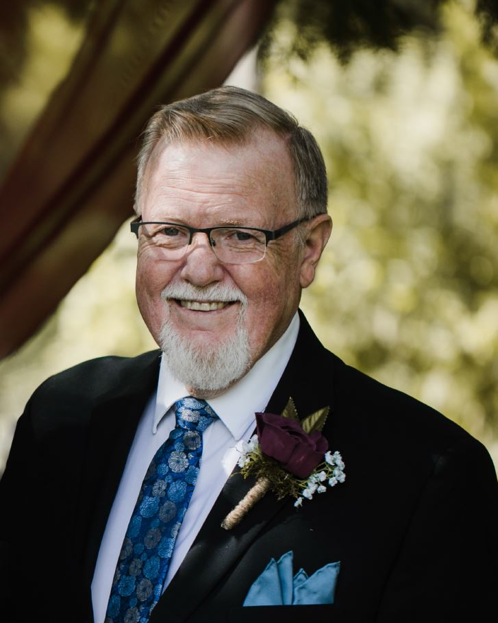 Portrait photo of Charlie Ball smiling at the camera.