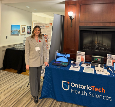 A photo of Sarah Pistritto with an Ontario Tech University table