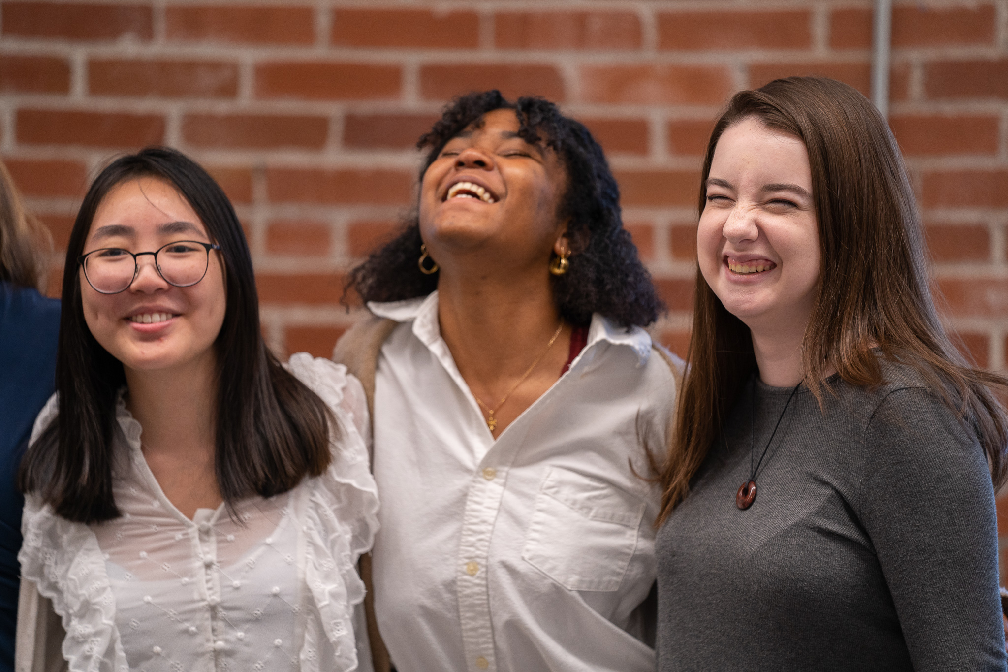 Three Women for STEM award recipients standing together, smiling and laughing