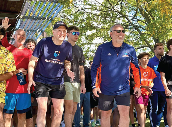 President Steven Murphy and Chancellor Mitch Frazer at the start line of the Chancellor's Challenge with fellow participants.