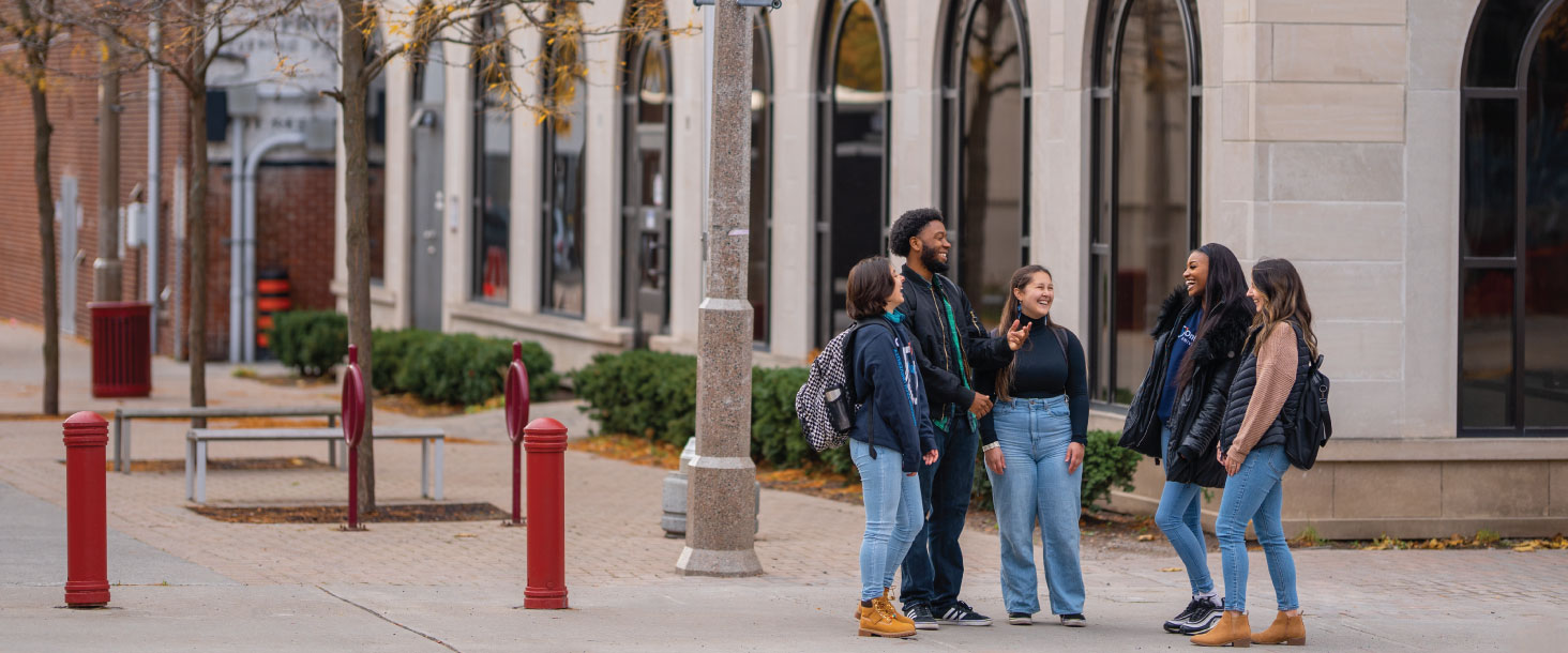 Students stand outside talking at Ontario Tech's downtown Oshawa campus location.