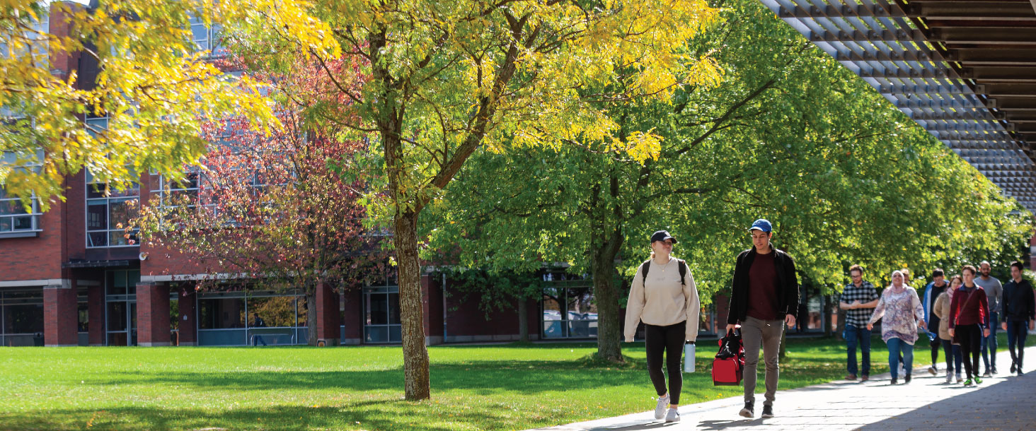 Students walking and talking in Polonsky Commons on a sunny, fall day.