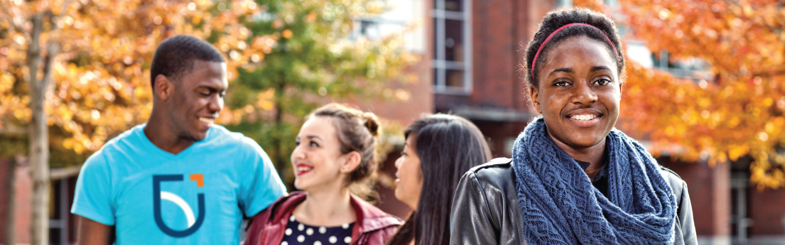 Students smiling in Polonsky Commons in the Fall
