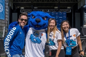 Hunter poses for a photo with a group of smiling people 