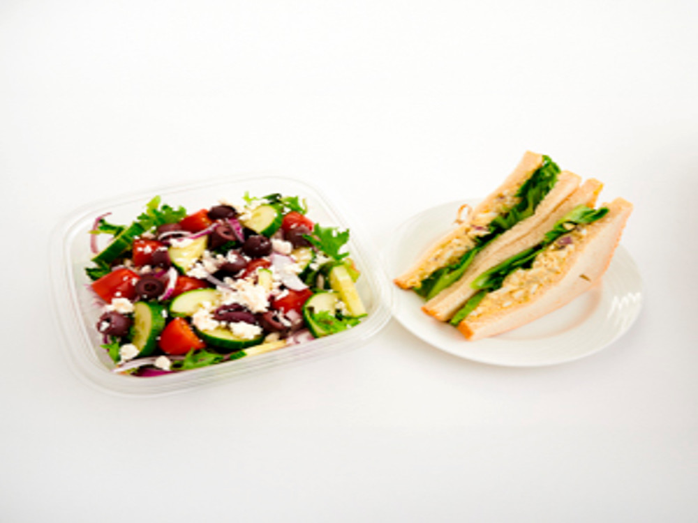 An image of a salad bowl and a plate of sandwich