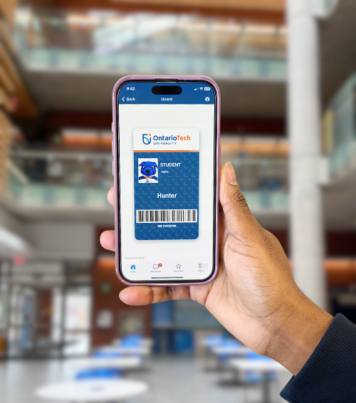 Someone holding a phone with the digitial Ucard on the screen