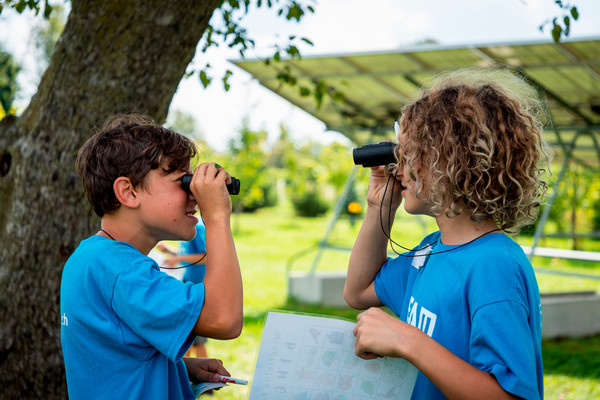 Turtle Island campers looking into binoculars.