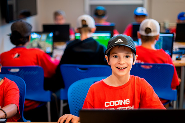 A camper using a laptop for coding at 2023 Summer Camps.