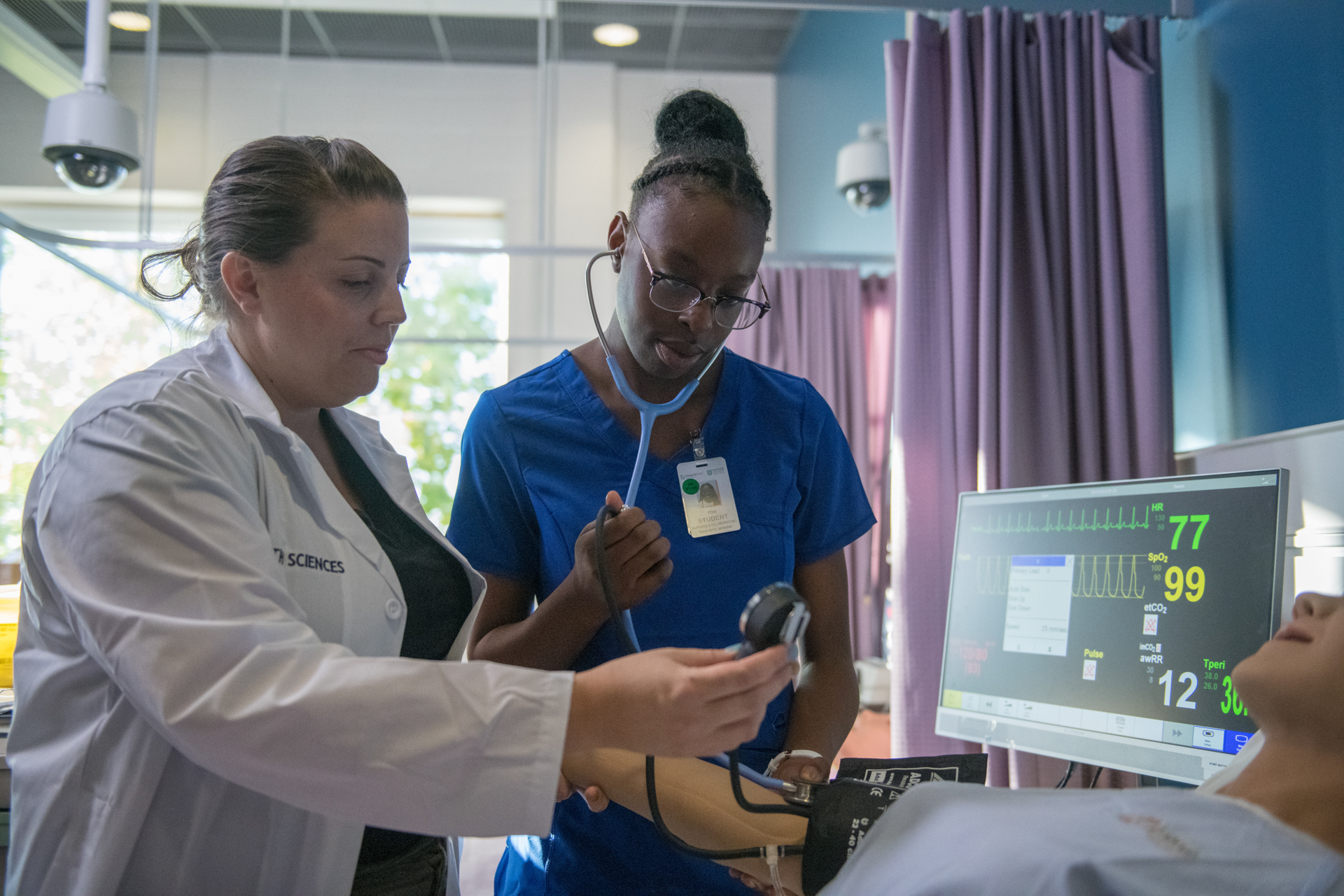 nurses standing around patient 