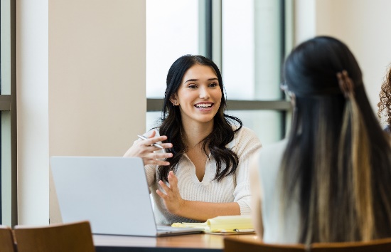 2 people discussing across a table