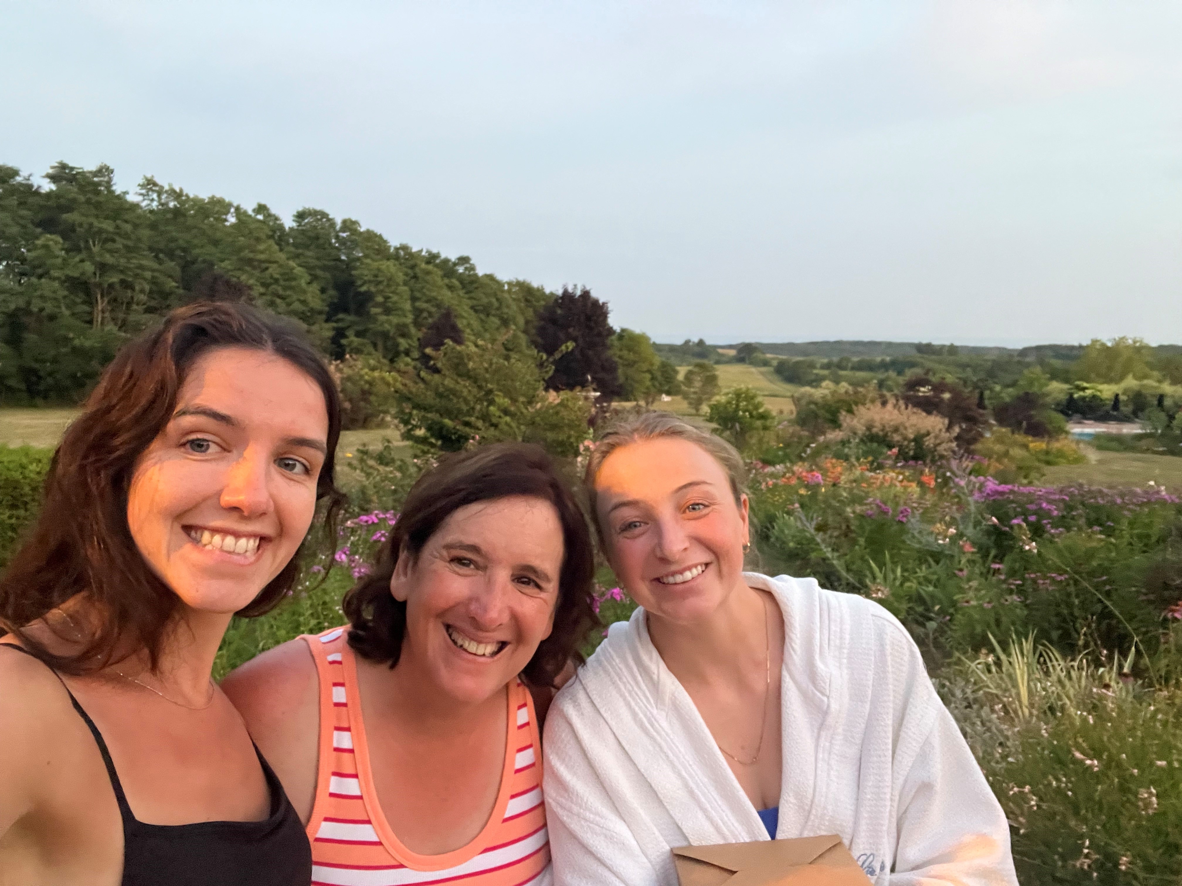 3 people smiling while taking a picture together
