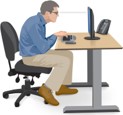 A photo of a man sitting at a desk with his back hunched - an example of how not to sit.