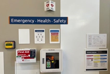 Image of Emergency Health Safety Station on campus, including first aid kit and AED