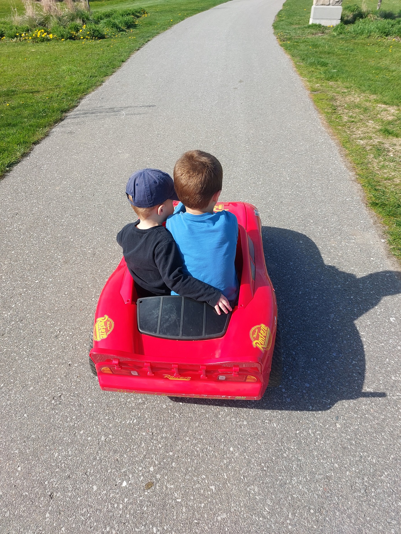 Christine Gray's sons, riding in a red car