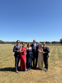 Lauren Crawley and five family members posing together outdoors at a family wedding in Europe.