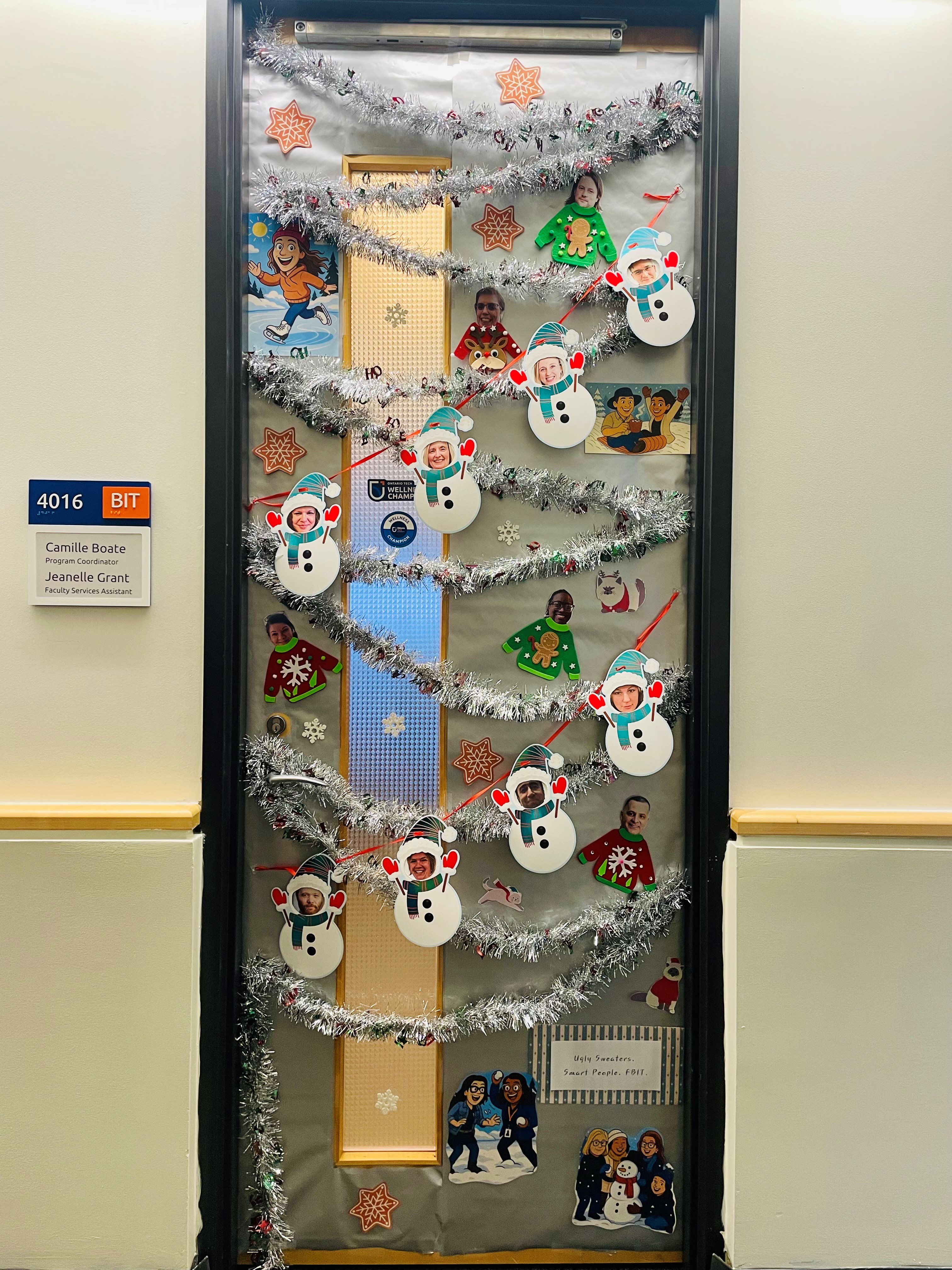 Office door decorated for the holidays with snowman, stars, and tinsel