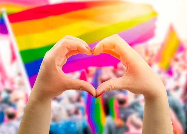 Pride flag with hands curled to make a heart