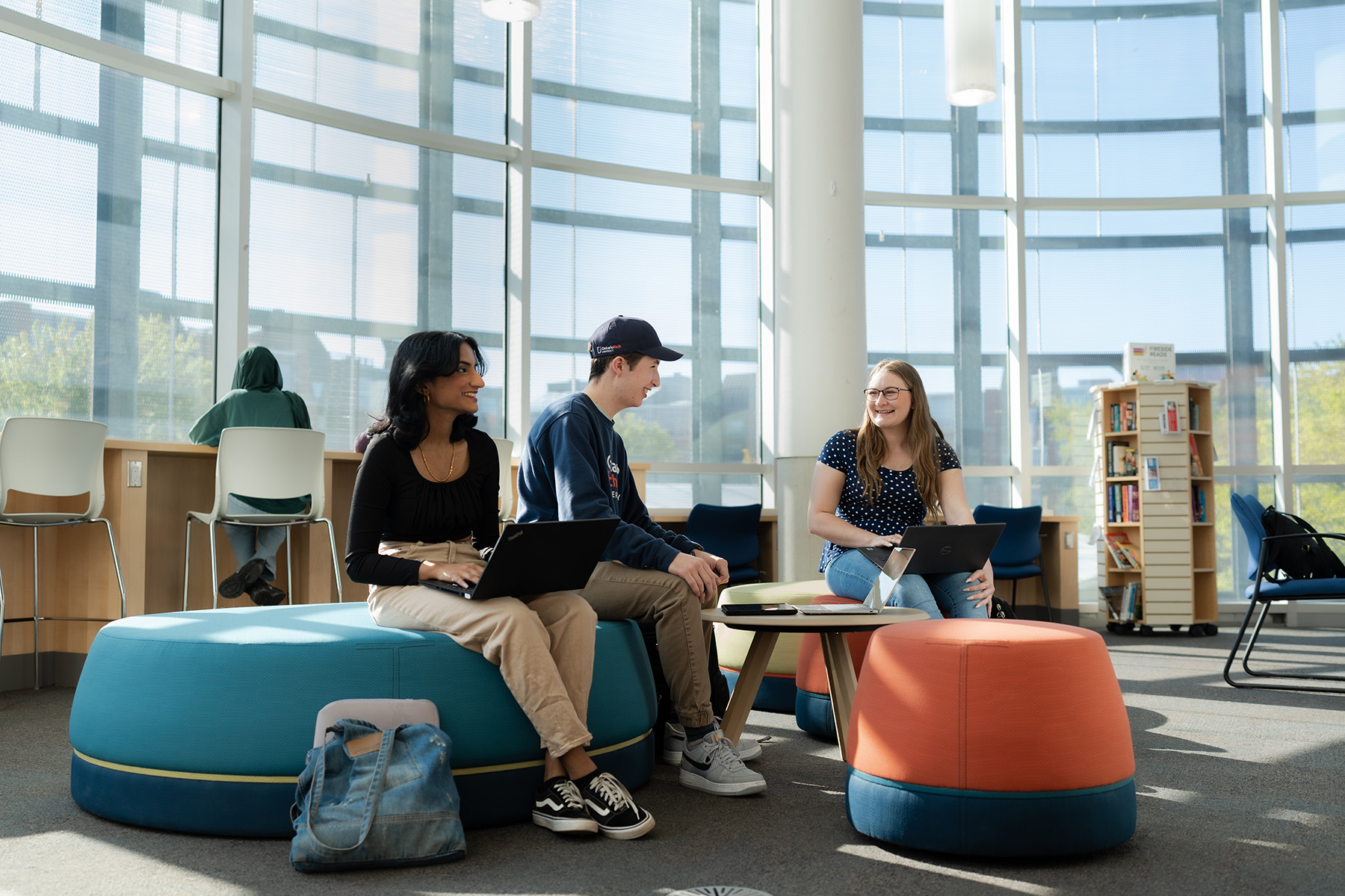 students sit and chat in the fireside reading room