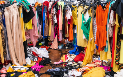 Clothing is messily placed all over a store.