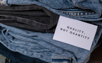 Piles of jeans with a tag reading "Quality, not quantity"