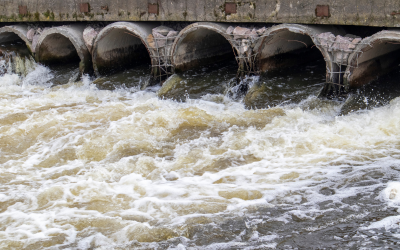 Waste water pipes flowing into open water.