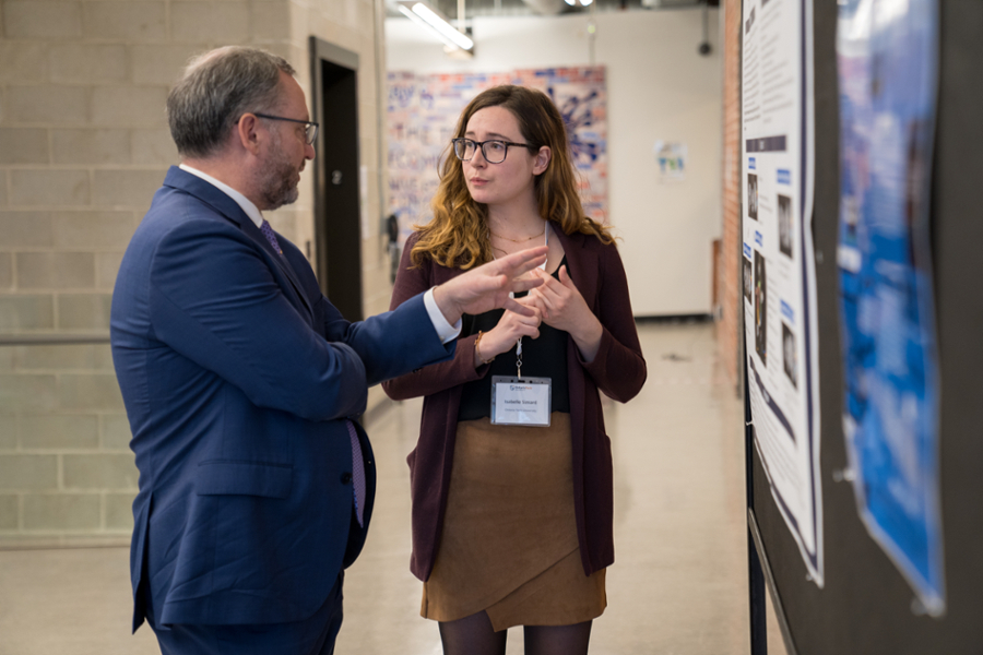 President Steven Murphy speaking with Isabelle Simard (PhD, Forensic Psychology, class of 2022).