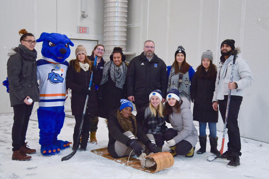 President Steven Murphy with 鶹ý University students and Hunter the Ridgeback inside ACE.