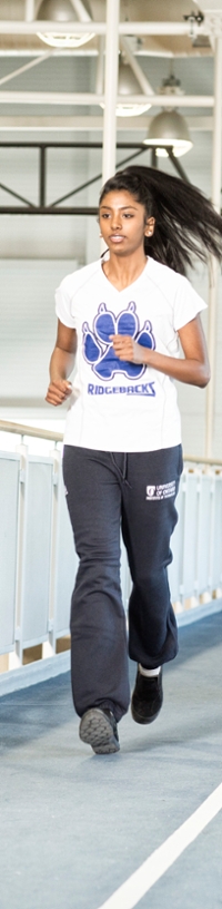 Student running on the CRWC indoor track