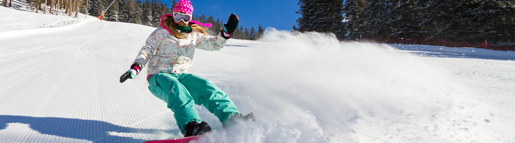 A student snowboarding in the winter