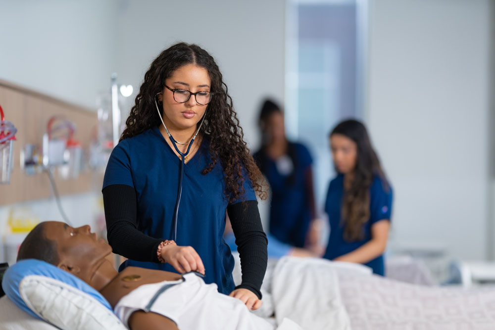 Student in nursing simulation lab.