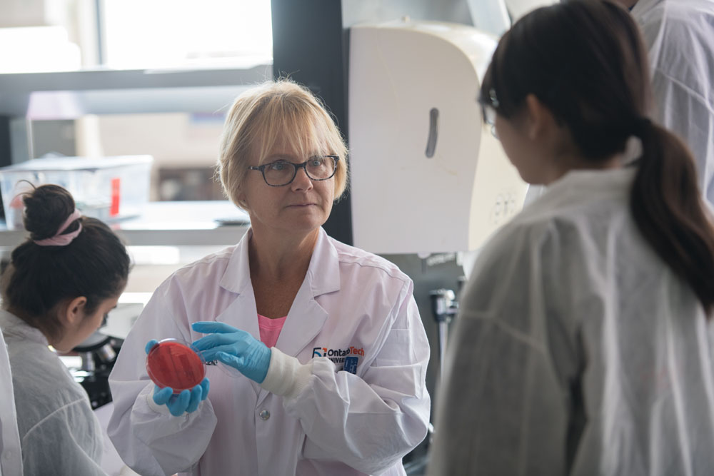 Professor with student in biology lab. 