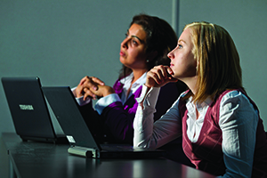 Students with laptops in a classroom