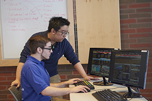 two students at two monitors