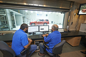 Two graduate students monitoring test in ACE facility