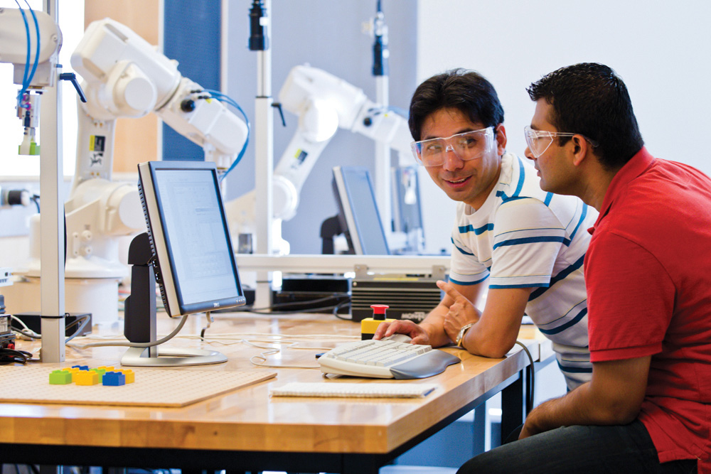 Engineering students working with a computer.