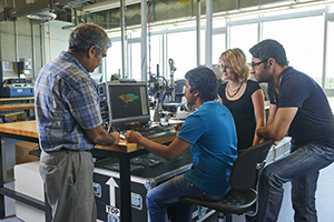 Two Automotive Engineering working on a car at the university