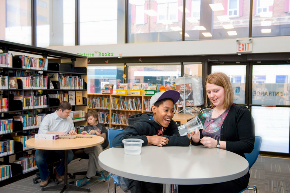 teacher and students at a table