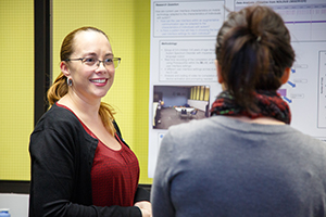 two people looking at a project on a display