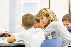 teacher and students at a table