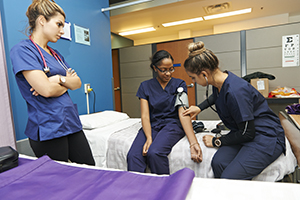 Nursing students using a stethoscope. 