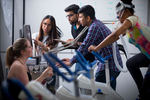 Students on exercise bikes.