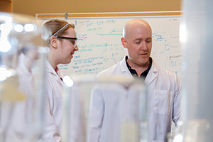 Student with prof in lab