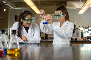 Two student using a microscope in a laboratory 