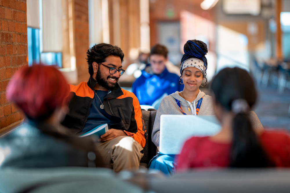 Students sitting inside Charles Hall. 