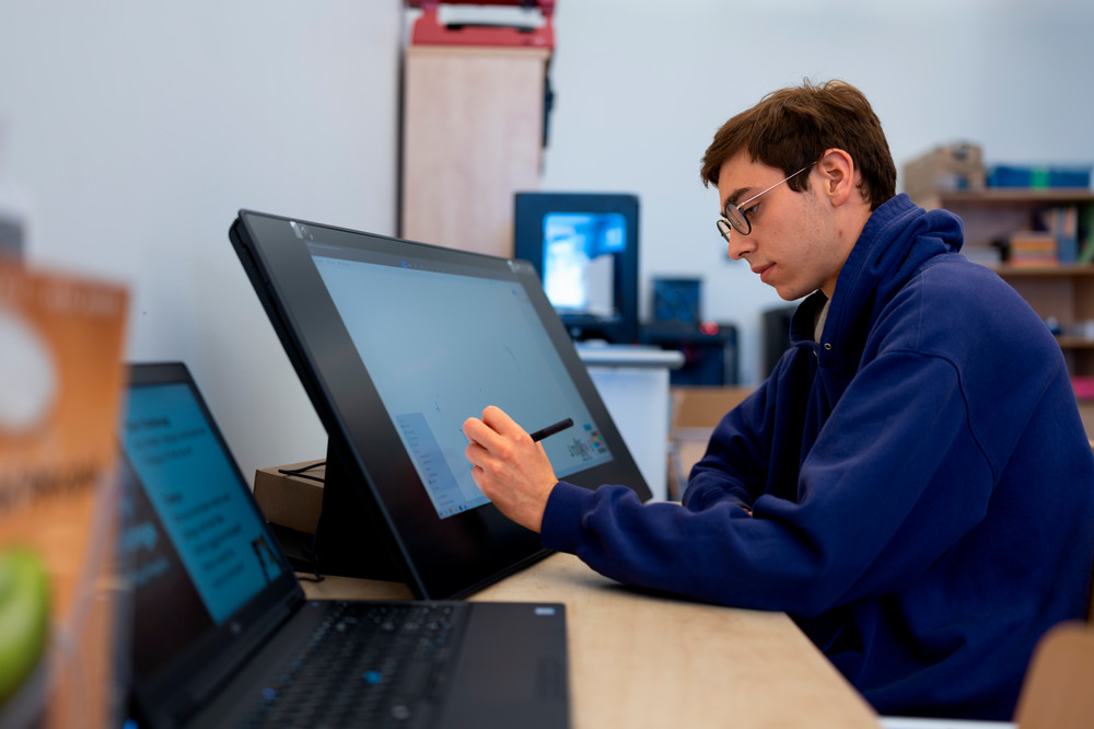Student at computer in library.