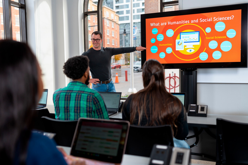 students sitting in a classroom looking at a presentation